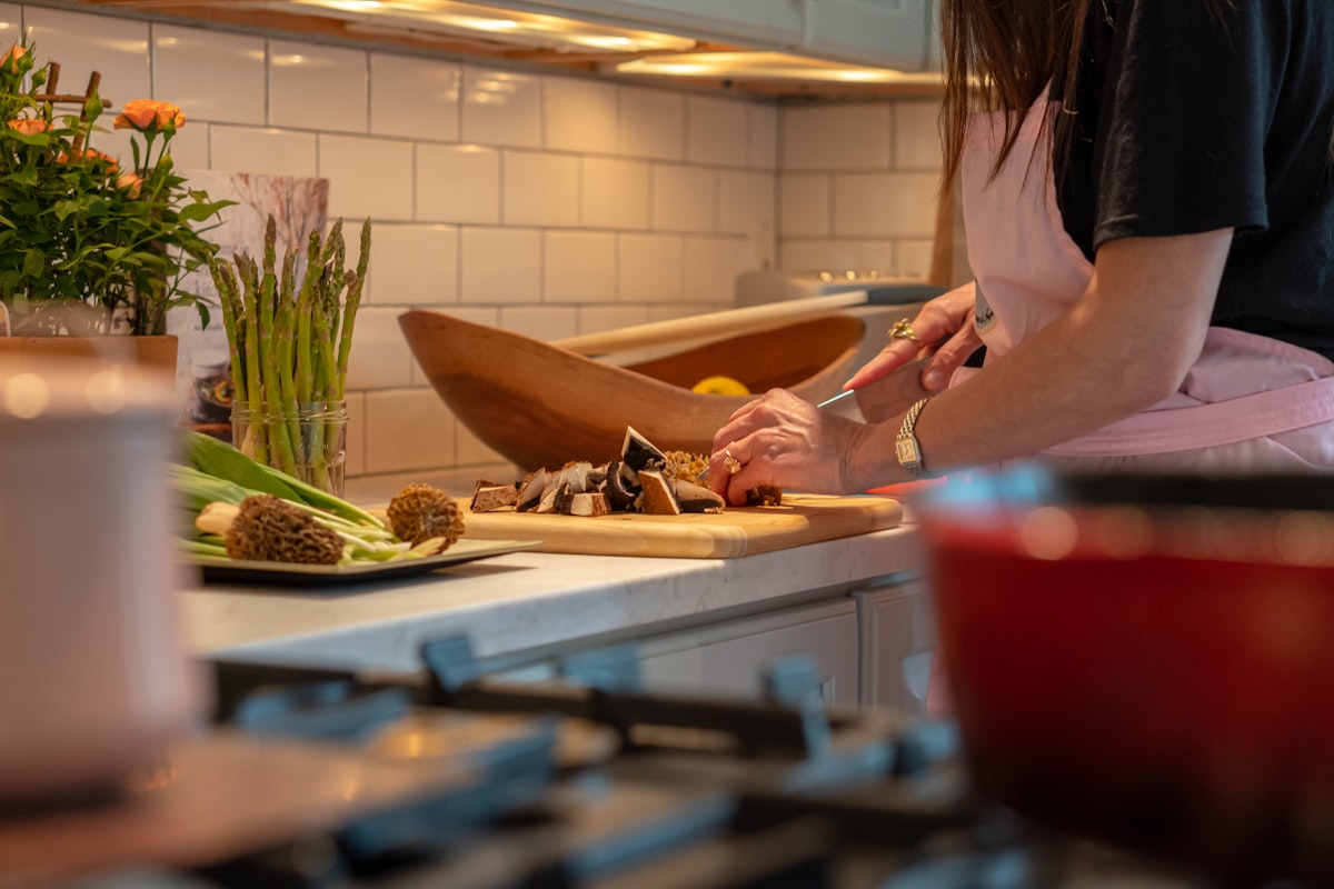 Warm soups with fresh herbs and vegetables in bowls